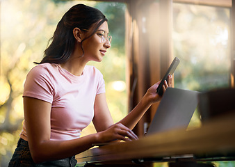 Image showing Research, phone and laptop with woman in cafe browsing for social media, internet and digital. Technology, remote work and contact with girl reading online at table for freelancer, news and planning