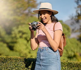 Image showing Photography, tourism and woman with a camera in nature for travel memory in Sweden. Summer, tourist and photographer looking at photos while traveling on a vacation in a park or botanical garden