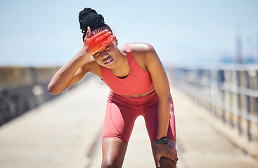 Image showing Headache, fever and black woman runner by the sea with fitness, training and running injury. Head pain, sports and athlete with joint, muscle and inflammation problem with blurred background