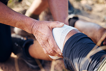 Image showing Sport bandage, first aid and hands of medical support for knee pain of elderly man hiking in mountain. Exercise, fitness and paramedic in nature with senior athlete hurt from sports accident outdoor