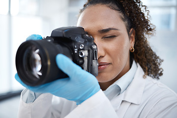 Image showing Camera, photography and medical with black woman in forensics laboratory for investigation, crime scene and evidence. Research, analytics and observation with girl and digital pictures for science