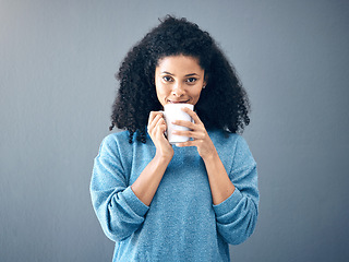 Image showing Coffee, tea and portrait of black woman drinking an espresso in a cup isolated in a studio gray background. Morning, relax and female with hot beverage with caffeine for energy and feeling happy