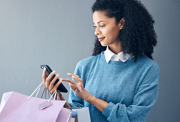 Image showing Shopping bag, phone or black woman for fashion sale, discount or luxury brand store. Mockup, internet or girl with smile on smartphone for social media, promo code or online retail website app news