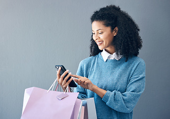 Image showing Shopping bag, phone or black woman in mockup studio for fashion sale, discount or luxury brand store. Happy or girl smile on smartphone for social media, promo code or online retail internet app news