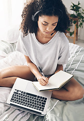 Image showing Book, writing and black woman with laptop and headphones for studying or online learning. Scholarship, student and female with headset, computer and notebook in virtual class on bed in bedroom home.