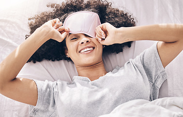 Image showing Sleeping, wake up and black woman with eye mask in bed, dream and refresh body and mind in apartment or hotel. Dreaming, rest and relaxation, smile and beauty sleep late on weekend morning in bedroom