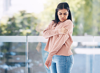 Image showing Arm, pain and mockup with an indian woman holding her shoulder on a glass background while suffering from cramp. Medical, anatomy or muscle and a person struggling with an injury from an accident