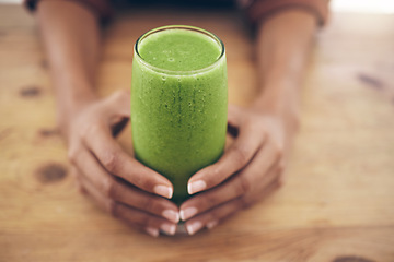 Image showing Hands, glass and smoothie with a black woman holding a health beverage for a weight loss diet or nutrition. Wellness, detox or drink with a healthy female enjoying a fresh fruit and mint juice