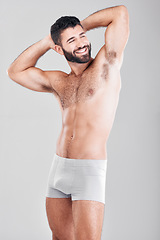 Image showing Body, underwear and strong man in studio for exercise, fitness and wellness on a grey background. Happy aesthetic model for health, lose weight motivation and stomach or sexy muscle on healthy diet