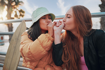 Image showing Playful, kiss and friends with a hand promise, support and secret in the city of California. Happy, together and women with affection, outdoor conversation and playing with happiness as besties