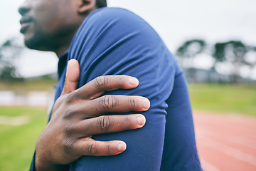 Image showing Sports, hands and black man with pain in arm from exercise, workout and marathon training in stadium. Fitness, runner and athlete with joint strain, body injury and medical emergency on running track