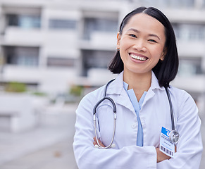 Image showing Leadership, happy and portrait of a doctor by hospital with success after surgery or consultation. Happiness, smile and Asian female healthcare worker with confidence standing outdoor medical clinic.