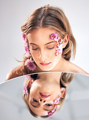Image showing Beauty face, mirror reflection and woman with flower product, sustainable agriculture and natural skincare. Facial makeup, nature plant cosmetics and eco friendly girl isolated on studio background