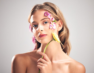 Image showing Beauty, flower and portrait of woman in studio with a skincare, natural and face routine. Floral, health and female model with organic, self care and fresh skin or facial treatment by gray background