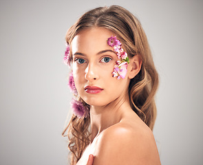 Image showing Beauty, flower and portrait of woman in studio for natural cosmetics, skincare wellness and makeup products. Spring, art and girl with petal on face for spa aesthetic, luxury facial and cosmetology