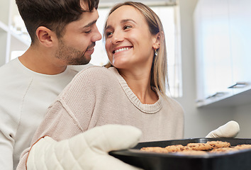 Image showing Love, kitchen and couple baking cookies together for fun, bonding and romance in their home. Bake smile and happy young man and woman preparing biscuits or snacks for party, event or dessert at house