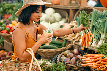 Image showing Vegetables, market and black woman shopping for grocery, natural and vegan food at small business. Farm supplier, carrot and young person or customer with basket for retail product, nutrition or diet