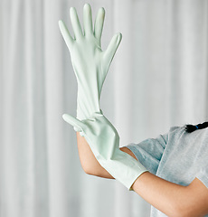 Image showing Cleaning gloves, hands and woman in a home ready to start bacteria and mess removal for safety. House, cleaner and maintenance of a female housekeeping employee with rubber glove for clean household