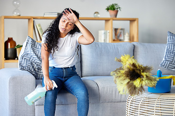 Image showing Tired woman, housekeeper and detergent on sofa in the living room for cleaning, hygiene or disinfection at home. Exhausted female maid or cleaner in burnout, stress or fatigue for routine maintenance