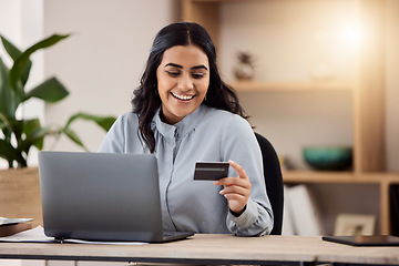 Image showing Credit card, laptop and happy woman for online shopping, e commerce and payment on fintech in her office. Employee, indian person or worker on computer for internet banking, online investment or sale