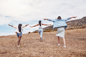 Image showing Freedom, nature and friends running together outdoor for adventure, fun or exploring the wilderness. Run, autumn and excited with a woman friend group playing outside while bonding from the back