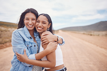 Image showing Portrait, hug and friends on a road trip with mockup on a dirt road outdoor in nature for adventure together. Desert, travel or freedom with a young woman and friend hugging outsode on holiday