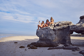 Image showing Friends, beach and selfie for diversity on a rock outdoor for holiday or vacation in summer. Group of women together at sea or ocean for travel in Bali for freedom in nature with water and blue sky