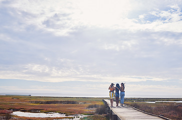 Image showing Travel, friends and women walking while on a vacation, adventure or outdoor journey in nature. Freedom, bonding and female best friends on a walk while on a holiday or weekend trip in the countryside