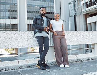 Image showing Date, urban and portrait of an African couple in the city for fashion, weekend fun and vacation. Fashionable, serious and black man and woman standing on a bridge for bonding and time in South Africa