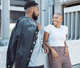 Image showing Talking, black people and couple of friends in a city with happiness and conversation outdoor. Urban lifestyle, happy woman and communication by a building with partner and smile from discussion