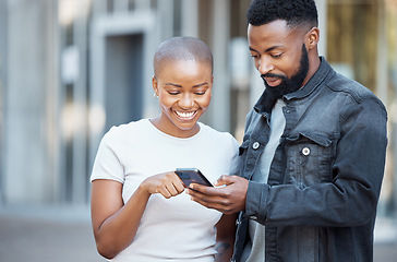 Image showing City, happy and couple browsing on a phone with social media, mobile app or the internet. Technology, 5g network and young African man and woman scrolling on a website with a cellphone in town.