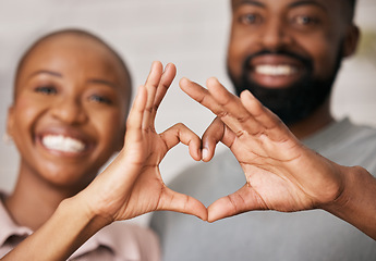 Image showing Love, hands in heart and black couple with smile for relationship, dating and commitment in home. Happy, emoji and face of black woman and man smile with hand shape for bonding, romance and trust