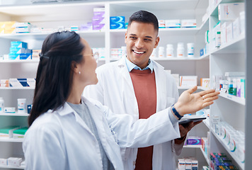 Image showing Pharmacy, employees and discussion with healthcare, inventory for stock and teamwork. Pharmacist, man and woman talking, planning and prescriptions with happiness, staff and medical professionals