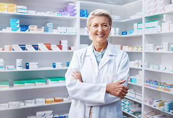 Image showing Portrait, senior woman and pharmacist with arms crossed in pharmacy, drugstore or shop. Healthcare, wellness and happy, proud and confident elderly female medical professional or doctor from Canada.