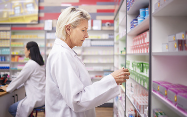 Image showing Pharmacy, doctor and medicine retail store with mockup stock on shelf for healthcare industry. Pharmacist woman reading info on pills, box or Pharma product for medical service, health and wellness