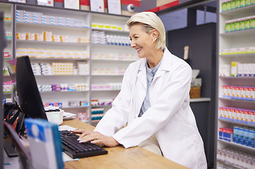 Image showing Pharmacy, computer database and senior woman pharmacist working of medicine research. Pharmaceutical data, typing and healthcare employee smile checking online information for medical prescription