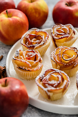 Image showing Freshly baked apple roses cakes served on white plate, flat lay