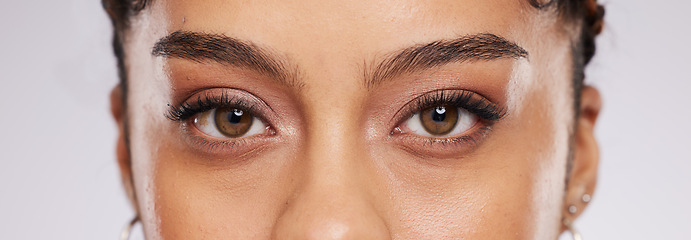 Image showing Eyes, vision and beauty with contact lens and black woman, eye care and cosmetics with closeup on studio background. Microblading, eyebrow and lashes, face and skin in portrait with optometry