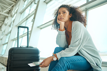 Image showing Airport, travel delay and sad woman with anxiety for immigration, passport problem or schedule. Young USA person with luggage and stress, worry or thinking of flight fail, crisis or identity mistake