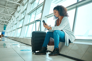 Image showing Travel, phone and black woman at airport on a video call waiting for plane travel and flight. Online, mobile connection and smile of a young female sitting at airplane terminal waiting for transport