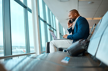 Image showing Phone call, travel and businessman on a laptop in the airport for work company trip in the city. Technology, communication and African male employee on mobile conversation waiting to board his flight