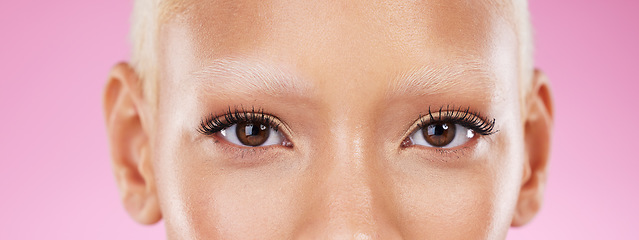 Image showing Beauty, portrait and eyes with mascara in a studio with a natural cosmetic or makeup routine. Eyelashes, self care and closeup of beautiful female model with eye cosmetics isolated by pink background