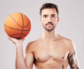 Image showing Portrait, basketball and man with fitness, sport and exercise with motivation on grey studio background. Face, male athlete and player with training, workout or practice for tournament or competition