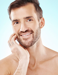 Image showing Skincare, grooming and portrait of a handsome man isolated on a blue background in studio. Clean, beauty and face of a model smiling for cosmetics, dermatology glow and cosmetology on a backdrop