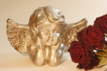 Image showing Cupid with red roses