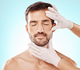 Image showing Man, face and facial care, hands and cosmetic service with beauty, healthy skin and glow on blue background. Dermatology, cosmetics and procedure, health and skincare with wellness and collagen