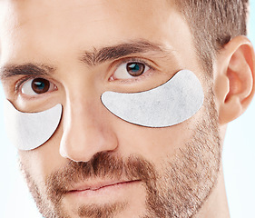 Image showing Eye beauty, man portrait and treatment patches for eyes in a isolated studio with white background. Skincare, spa wellness and facial for model face with cosmetics, dermatology and detox with mask