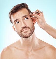 Image showing Hair removal, eyebrows and grooming with man and tweezers for beauty, hygiene and self care. Cosmetology, treatment and facial growth with model and tool for morning routine, trimming and cleaning