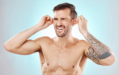 Image showing Ear cleaning, cotton bud and wellness of a man with blue background in a studio. Healthcare, grooming and self care of a man doing morning routine for health, hygiene and wellbeing treatment