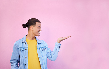 Image showing Happy, hand and of a man in a studio with mockup space for advertisement, product placement or marketing. Happiness, smile and male model showing mock up or copyspace isolated by a pink background.